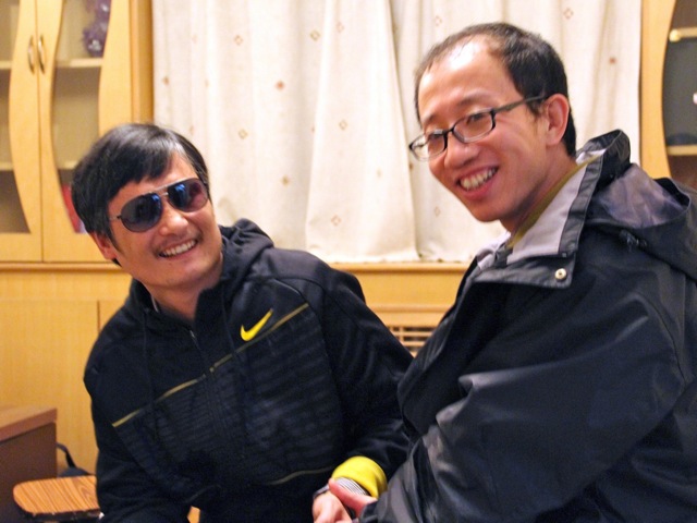 outspoken government critic Hu Jia (R) sharing a light moment with blind lawyer Chen Guangcheng