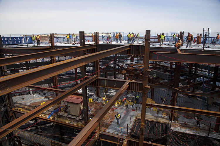 Ironworkers weld steel decking at the top of One World Trade Center