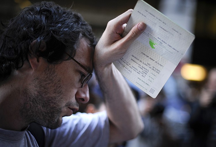 A man holds his savings book on May 14 during a protest held outside Caja Madrid's headquarters in Madrid