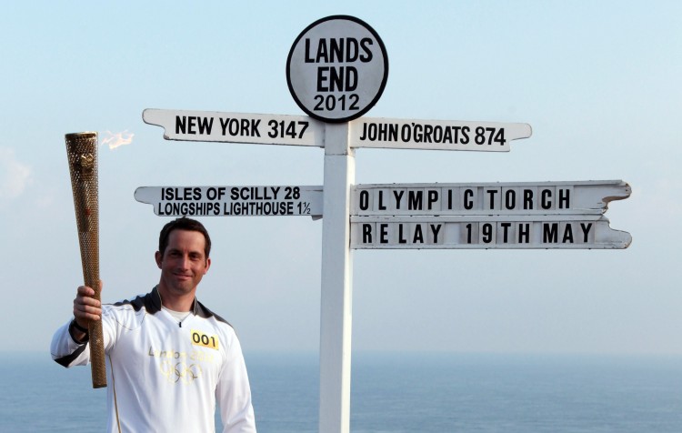 Olympic gold medal sailor Ben Ainslie is the first London 2012 torchbearer. He sets off from the famous Land's End sign post. (Matt Cardy/Stringer/Getty Images Sport)