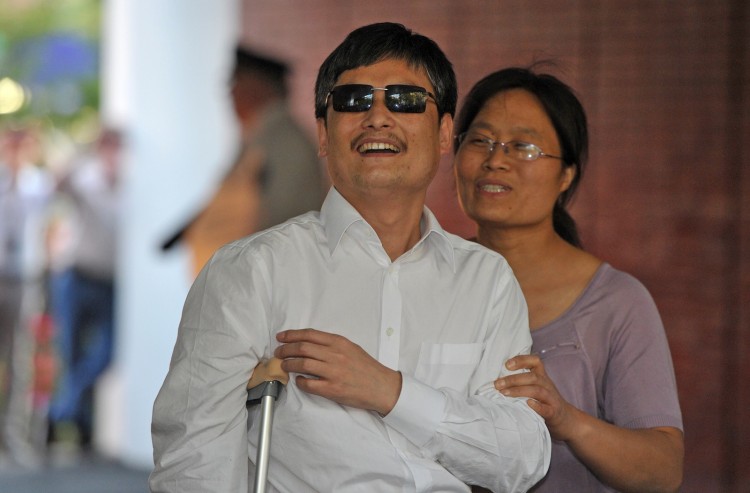 Chinese activist Chen Guangcheng (C) and his wife Yuan Weijing (R) arrive at the New York University Village apartment complex in Manhattan in New York, May 19 Mladen Antonov/AFP/GettyImages)