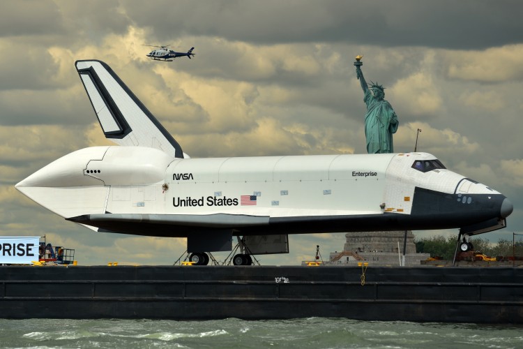 The space shuttle Enterprise is towed by barge past the Statue of Liberty June 6 on its way to the Intrepid Sea, Air and Space Museum where it will be permanently displayed. (Stand Honda/AFP/Getty Images 