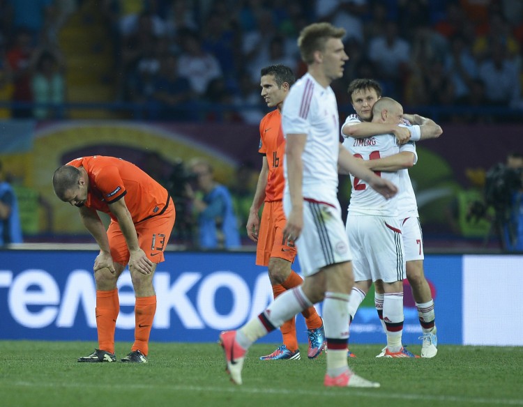 Denmark players celebrate Euro 2012's first major upset after beating Netherlands on Saturday in Ukraine. (Filippo Monteforte/AFP/GettyImages) 