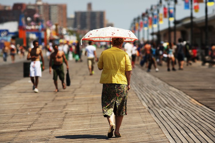 A woman walks down the boardwalk in Coney Island on July 12, 2012 in the Brooklyn borough of New York City. (Spencer Platt/Getty Images)