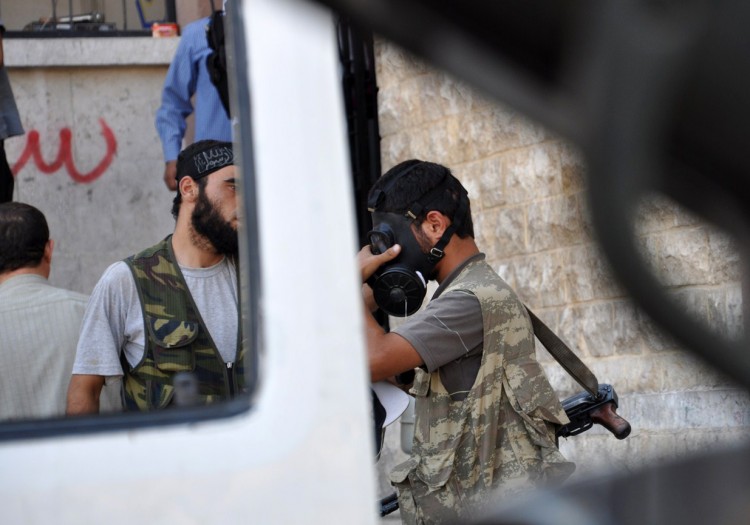 A Syrian opposition fighter tries a gasmask in the northern city of Aleppo on July 25, 2012. (Pierre Torres/AFP/GettyImages)