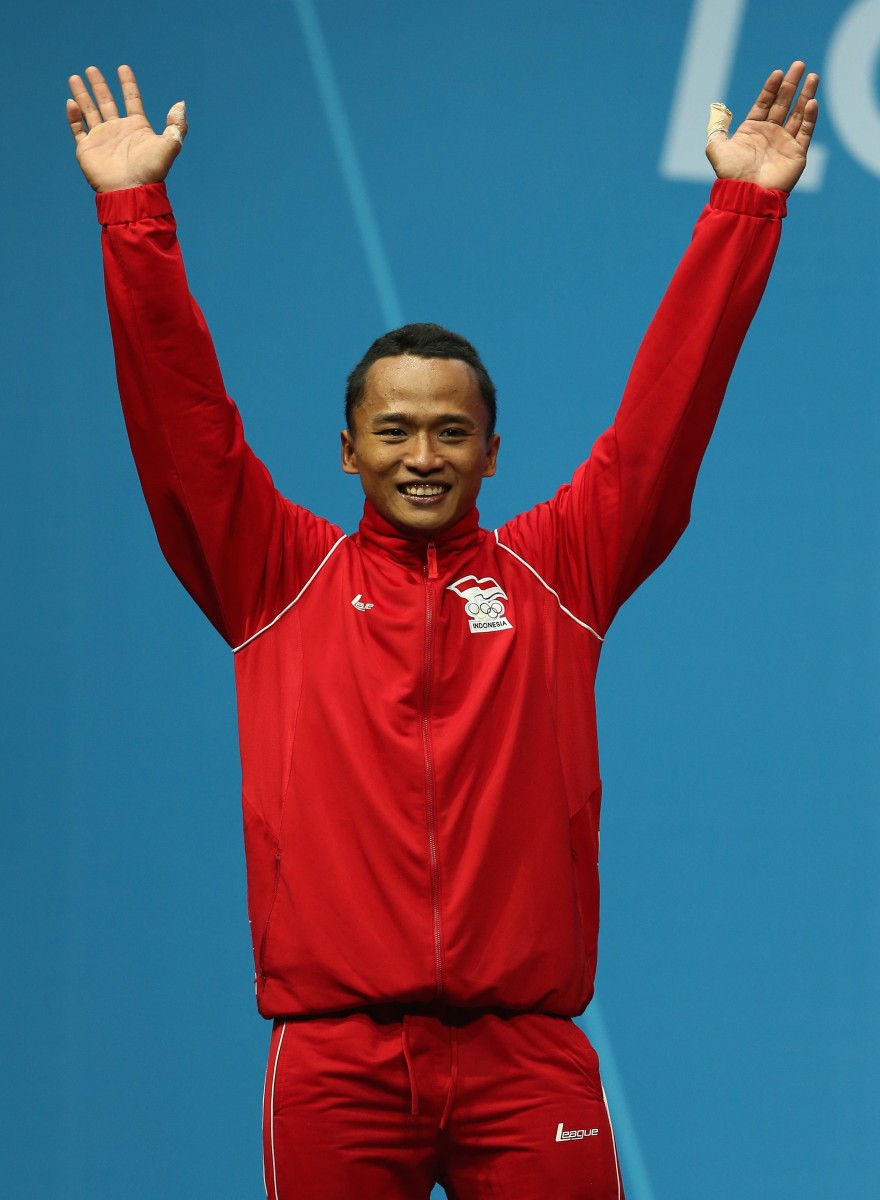 Triyatno Triyatno of Inodonesia celebrates winning the Silver medal during the Men's 69kg Weightlifting Final on Day 4 of the London 2012 Olympic Games at ExCeL on July 31, 2012 in London, England. (Quinn Rooney/Getty Images) 
