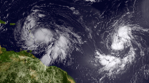 satellite image provided by National Oceanic and Atmospheric Administration (NOAA), Isaac (L) reached tropical storm status and is approaching the Lesser Antilles islands as it moves westward on August 22, 2012 in the Atlantic Ocean. (NOAA via Getty Images)