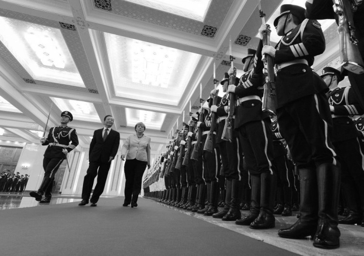 German Chancellor Angela Merkel (C) and Chinese Premier Wen Jiabao review an honor guard during her welcoming ceremony at the Great Hall of the People in Beijing on August 30, 2012.   (MARK RALSTON/AFP/GettyImages)