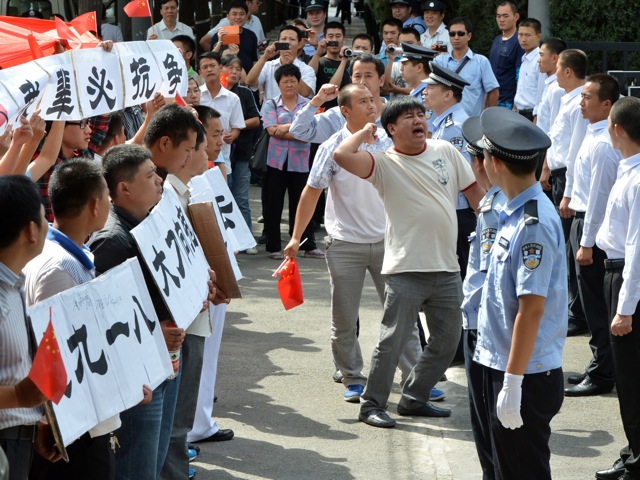 Anti-Japanese demonstrators shout outside the Japanese embassy in Beijing