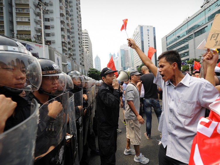 riot police stand firm against anti-Japan protesters