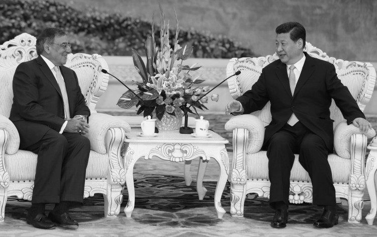 U.S. Secretary of Defense Leon Panetta sits with China's next communist leader Xi Jinping