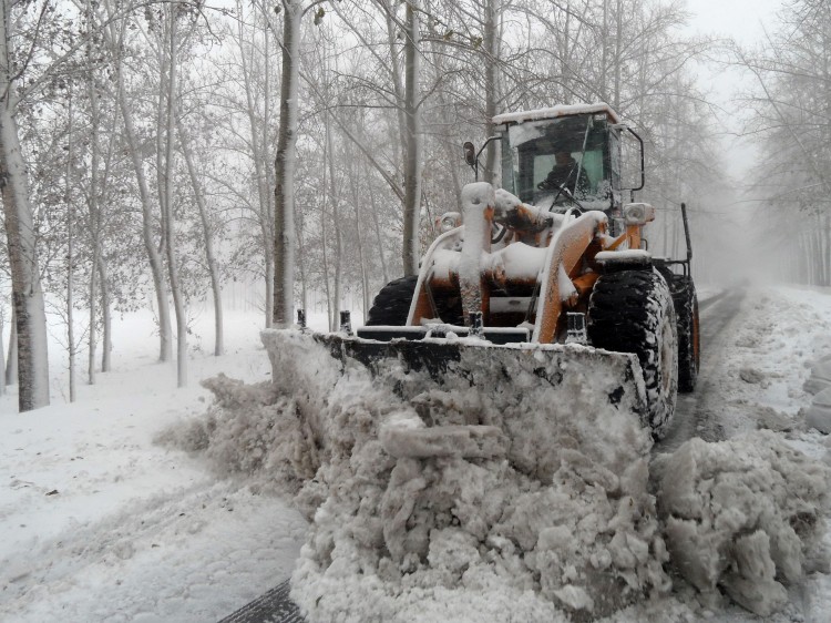 a bulldozer to clear a snow-covered street