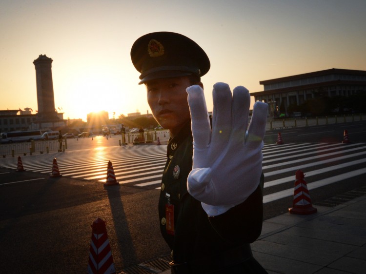 A Chinese paramilitary policeman reacts