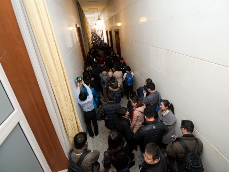 Journalists queue as they wait to be allowed access to the main hall