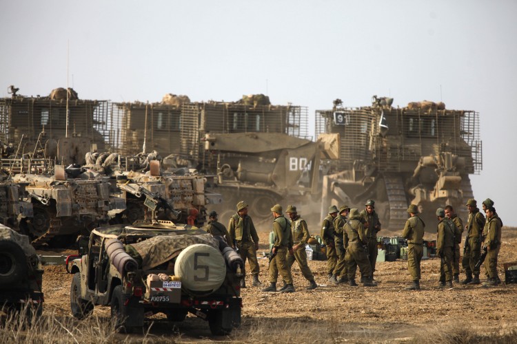 Israeli troops gather on Israel's border with the Gaza Strip