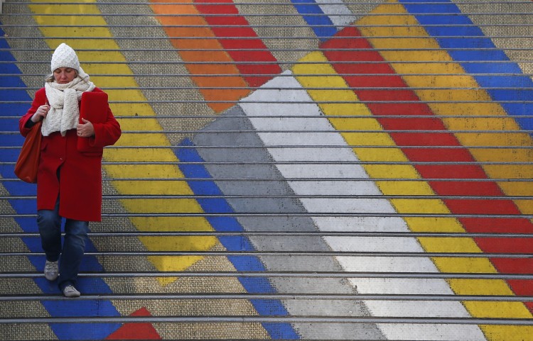 A woman walks down the colored steps of the Albertina museum