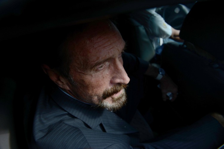 US anti-virus software pioneer John McAfee is transferred in a migration's car to the  Aurora international airport in Guatemala City on Dec. 12, 2012. (Johan Ordonez/AFP/Getty Images)