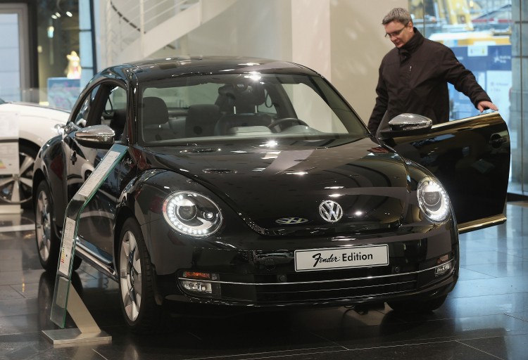 A visitor looks at a VW Beetle Fender edition at a Volkswagen Group showroom on Jan. 14, 2013 in Berlin, Germany. The company announced record earnings Feb. 22 but provided a cautious outlook for 2013. (Sean Gallup/Getty Images)