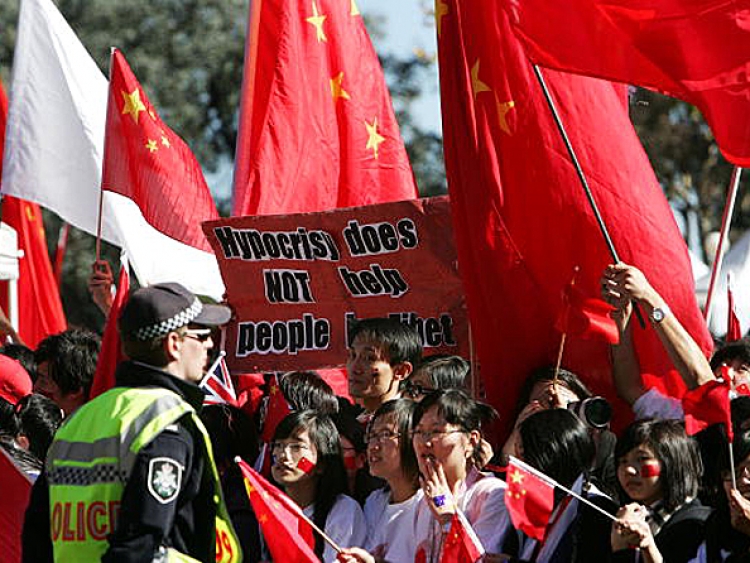Pro Chinese supporters wave flags during the Olympic Torch relay in Canberra, Australia. How many were paid to be there? (Lisa Maree Williams/Getty Images)