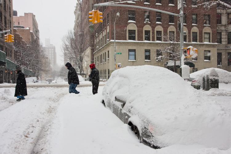 New Yorkers try to make their way about the city Friday morning amidst the third major snow storm of the season. (Jan Jekielek/Epoch Times)