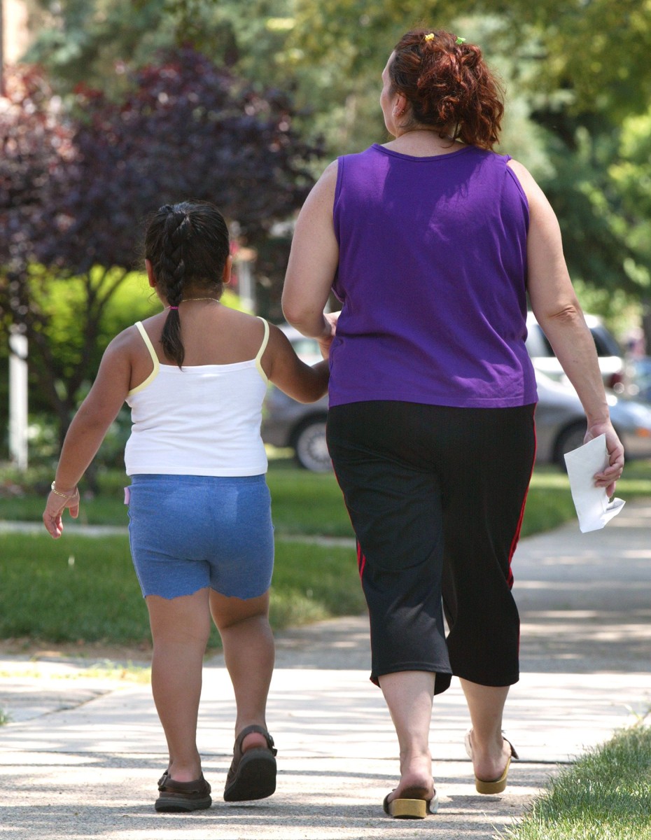 A young girl walks with her mother 