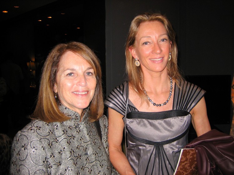 Cathy Tamraz (L), CEO of Business Wire, poses for a photograph with writer, Janet Crawford,