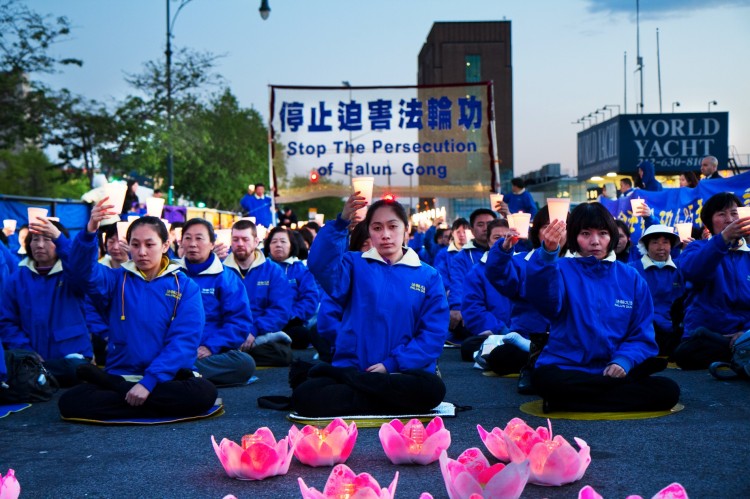 Falun Dafa practitioners hold a candlelight vigil as a peaceful protest near the Chinese Consulate in New York. The protest is against the Chinese Communist Party's 12-year persecution of the practice. 