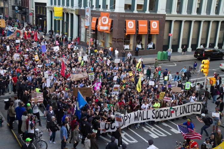 Thousands of Occupy Wall Street protesters march down Broadway toward Wall Street on Monday, forcing police to shut down all the side streets that intersect Broadway on May 1. (Benjamin Chasteen/The Epoch Times) 