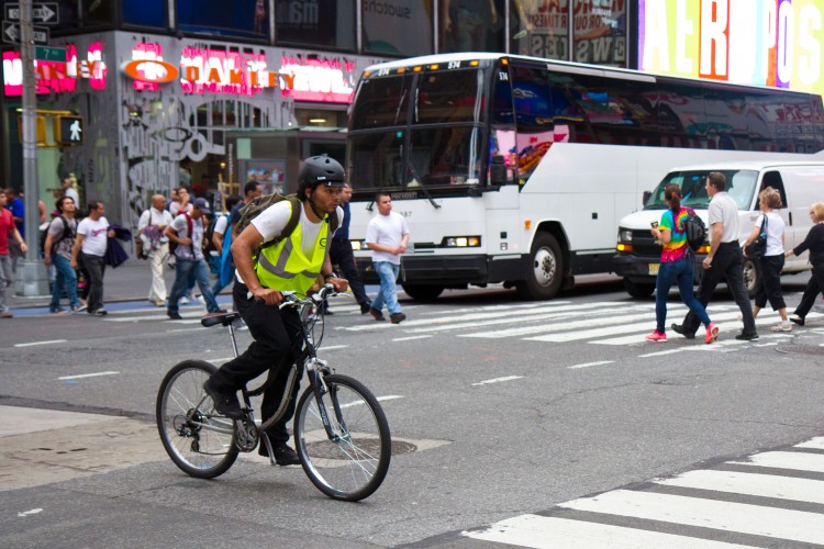 A cyclist crosses Seventh Avenue while riding on 44th Street in Times Square