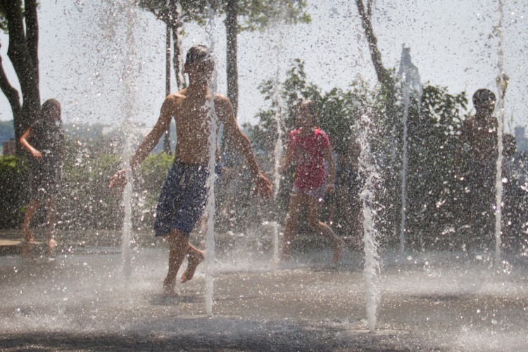 Children cool off at the water fountain play area in Manhattan's Battery Park on Friday June 29. New York City and much of the East Coast have been experiencing a second day of hot weather. (Benjamin Chasteen/The Epoch Times)