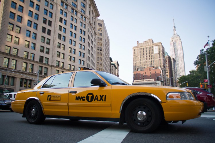 A taxi drives across 23rd Street in the Flatiron District of Manhattan on July 12 with the Empire State Building in the background