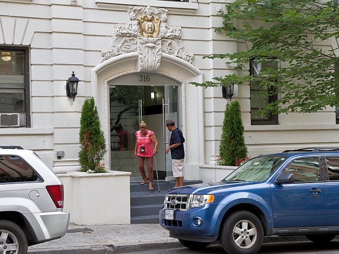 Two people walk out of the new family homeless shelter on 316 W. 95 Street in Manhattan on Aug. 7.