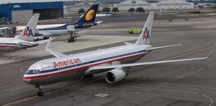 An American Airline plane costs down the runway at the JFK airport after landing on Aug. 14, 2012 in New York City. (Benjamin Chasteen/The Epoch Times)