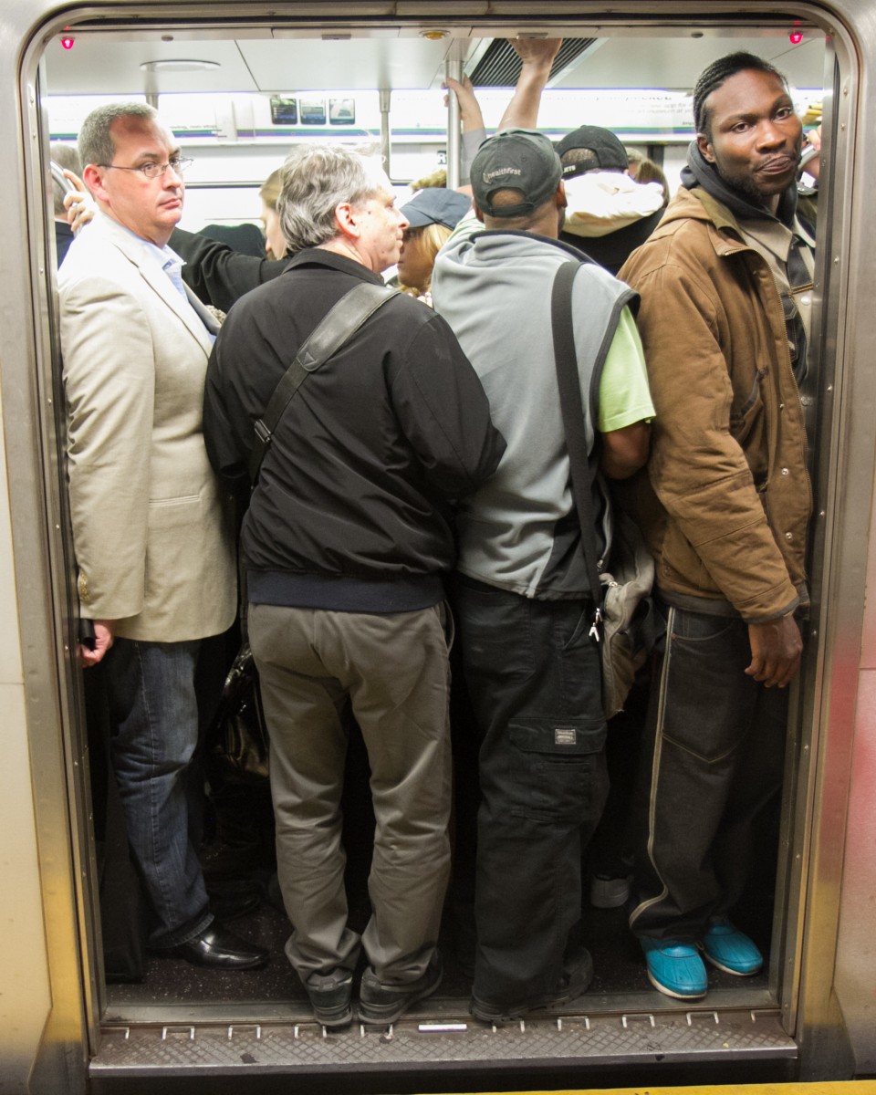 Commuters board a crowded No. 6 train heading to Grand Central Terminal during rush hour on Oct. 8 in New York. (Benjamin Chasteen/The Epoch Times)