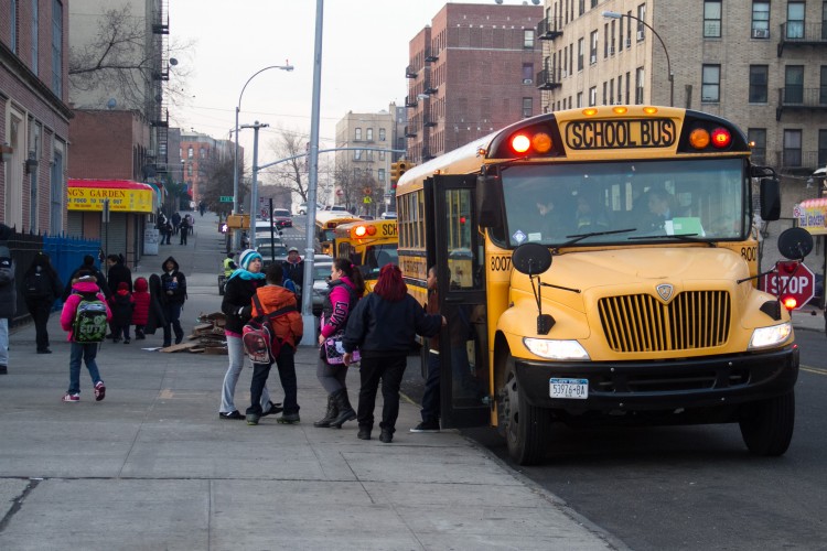  Students exit a school bus in front of their school in the Bronx on Jan. 9. (Benjamin Chasteen/The Epoch Times) 
