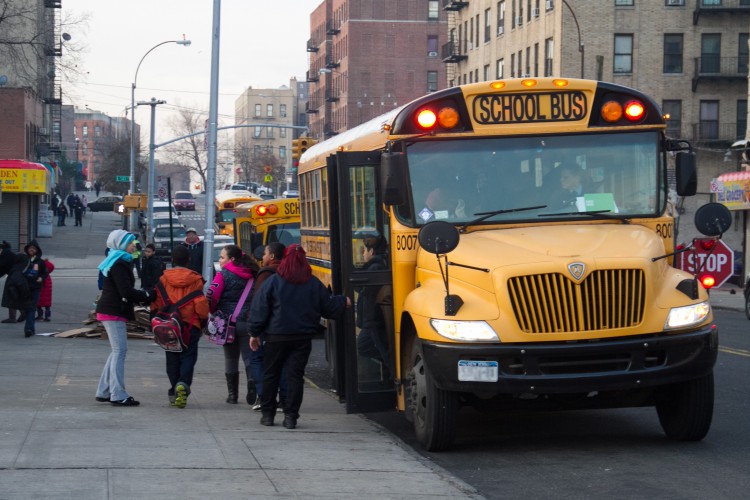 Students exit a school bus in front of their school in the Bronx on Jan. 9, 2013. Looks like these students will have to find other ways to get to school, come this Wednesday morning. (Benjamin Chasteen/The Epoch Times)