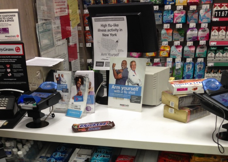 A corner store in Manhattan offers flu vaccination information on Jan. 10, 2013. (Benjamin Chasteen/The Epoch Times)