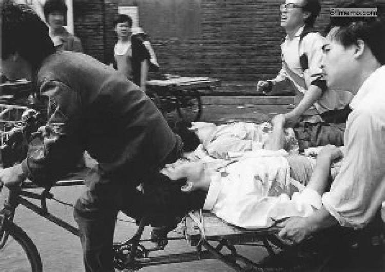 An injured student is taken away by friends after being shot by PLA troops in the Tienanmen Square Massacre. (www.64memo.org)