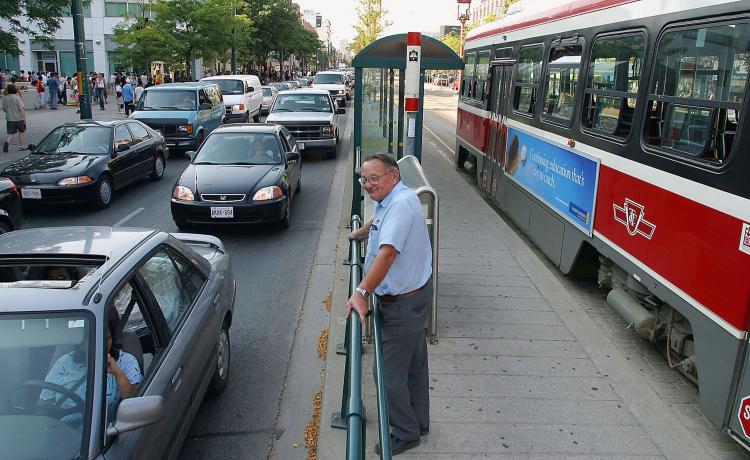 A Toronto Transit Commission street car driver stands by his streetcar. (Deborah Baic/Getty Images)
