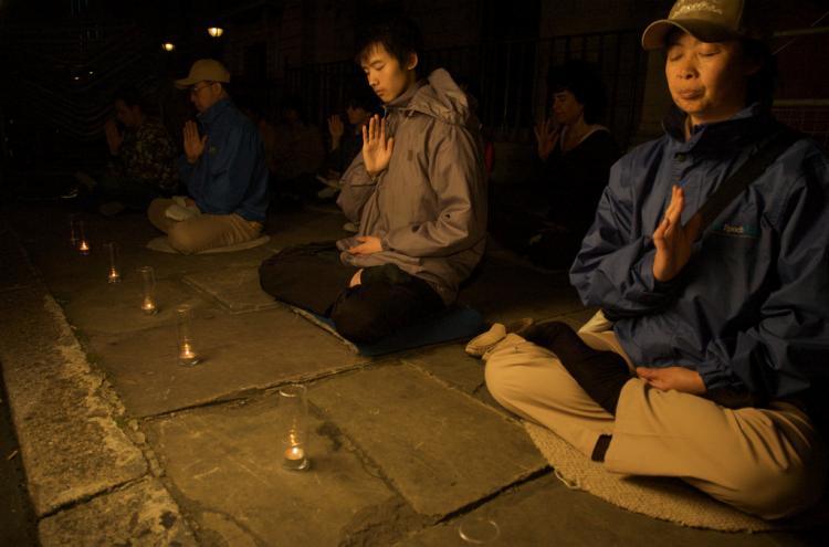 Falun Gong practitioners in London hold a candle-light vigil to mark nine years of human rights violations in China. (Edward Stephen/Epoch Times)