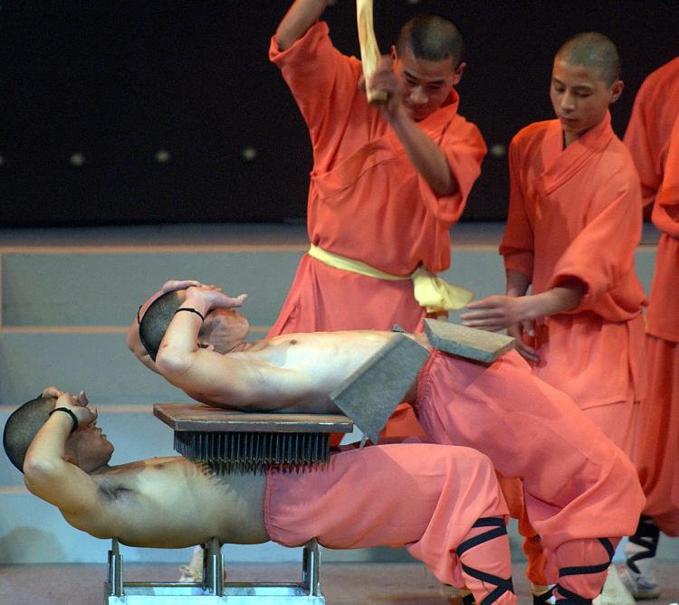 Shaolin monks demonstrate the strength they have cultivated through Chinese hard qigong. (Adek Berry/AFP/Getty Images)