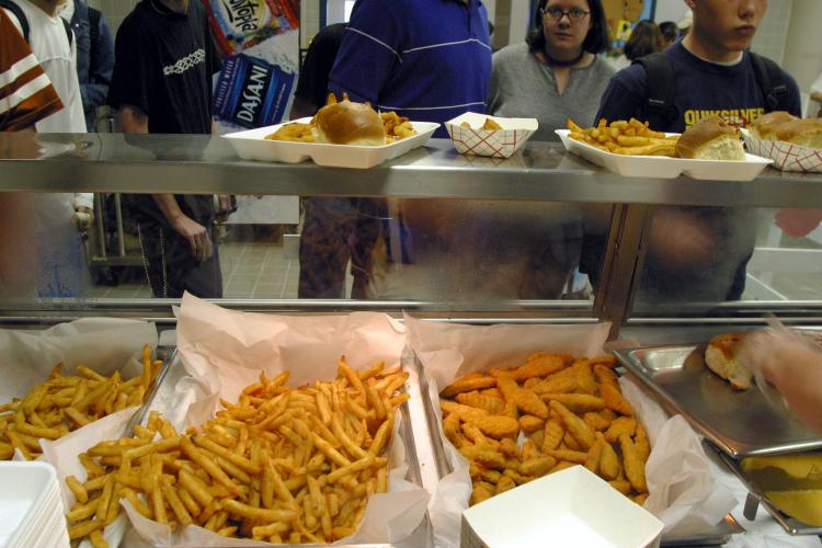 Students line up to receive french fries and chicken tenders during lunch in the cafeteria at a High School in Austin, Texas. The nationwide obesity epidemic has long been a concern of educators, health care professionals, and government agencies at local branches. (Jana Birchum/Getty Images )