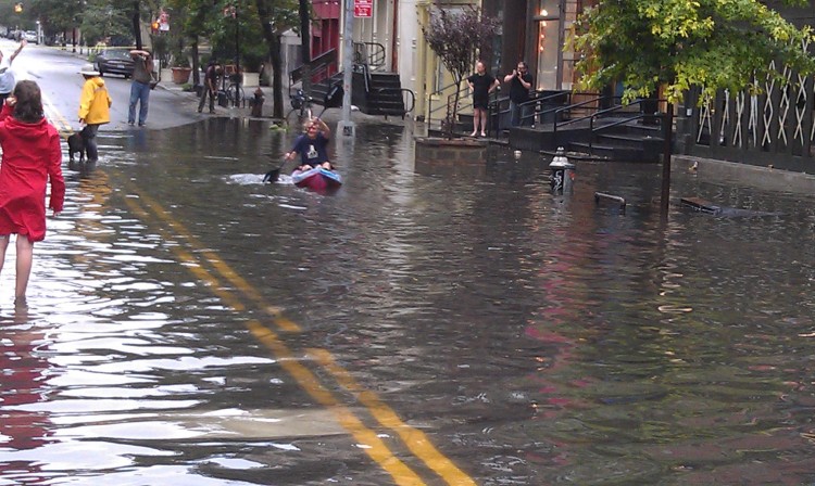 Despite Irene's arrival, a kayaker enjoys his time in the flood waters on Broadway in Soho. (Zack Stieber/The Epoch Times)
