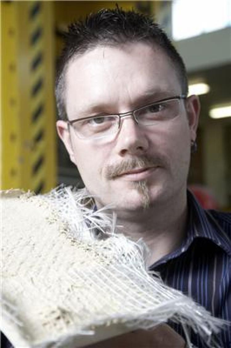 Dr Philip Purnell with composite material (Simon and Simon Photography)