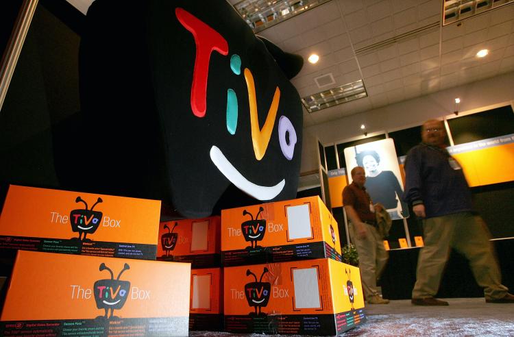  man walks by a display of TiVo boxes at the 2005 Consumer Electronics Show January 6, 2005 in Las Vegas, Nevada. (Justin Sullivan/Getty Images)