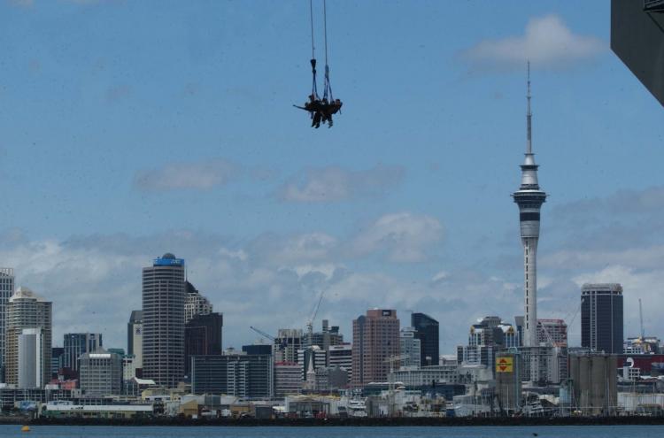 A group of five people roped together jump off Auckland's Harbour Bridge to celebrate 15 years of AJ Hackett bungy jumping in NZ in 2003.  (Phil Walter/Getty Images)