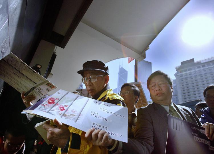 Hong Kong pro-democracy activists carry collected 3,000 Christmas cards and 2,000 post cards to mail out in Hong Kong, December 22, 2005. The Christmas and post cards were sent to Beijing for victims of June 4 Tiananmen Square massacre. (Samantha Sin/Getty Iamges )