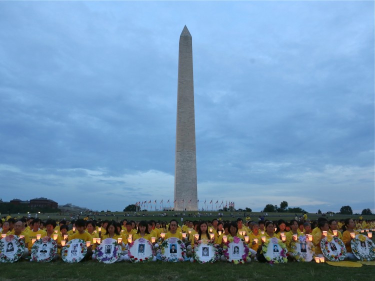 Falun Gong practitioners hold candles 