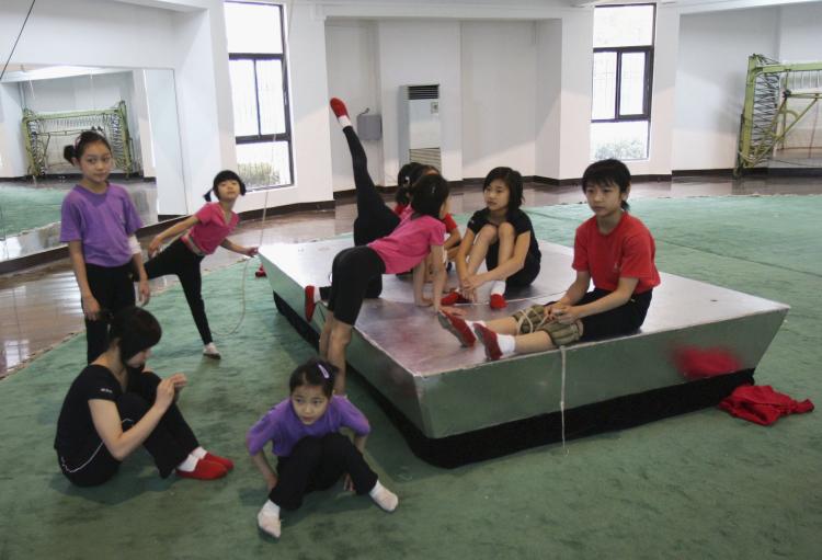 Young Chinese acrobats resting after training. In China enormous emphasis and funding are being given to elite sports, while neglecting sporting activities for the masses. The overall health of Chinese youth is in decline with the average fitness and health-related expenditure for a Beijing resident is only 73 yuan, ($11 US).  (Getty Images )