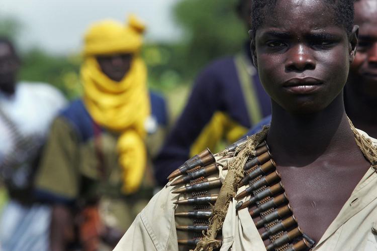 A rebel Sudanese Justice and Equality Movement (JEM) fighter stands at his base near the Chad border in the Darfur region of Sudan on Sept. 7, 2004, in Misterei, Sudan. Violence between Jem and the Sudanese forces escalated this past weekend. (Scott Nelson/Getty Images)